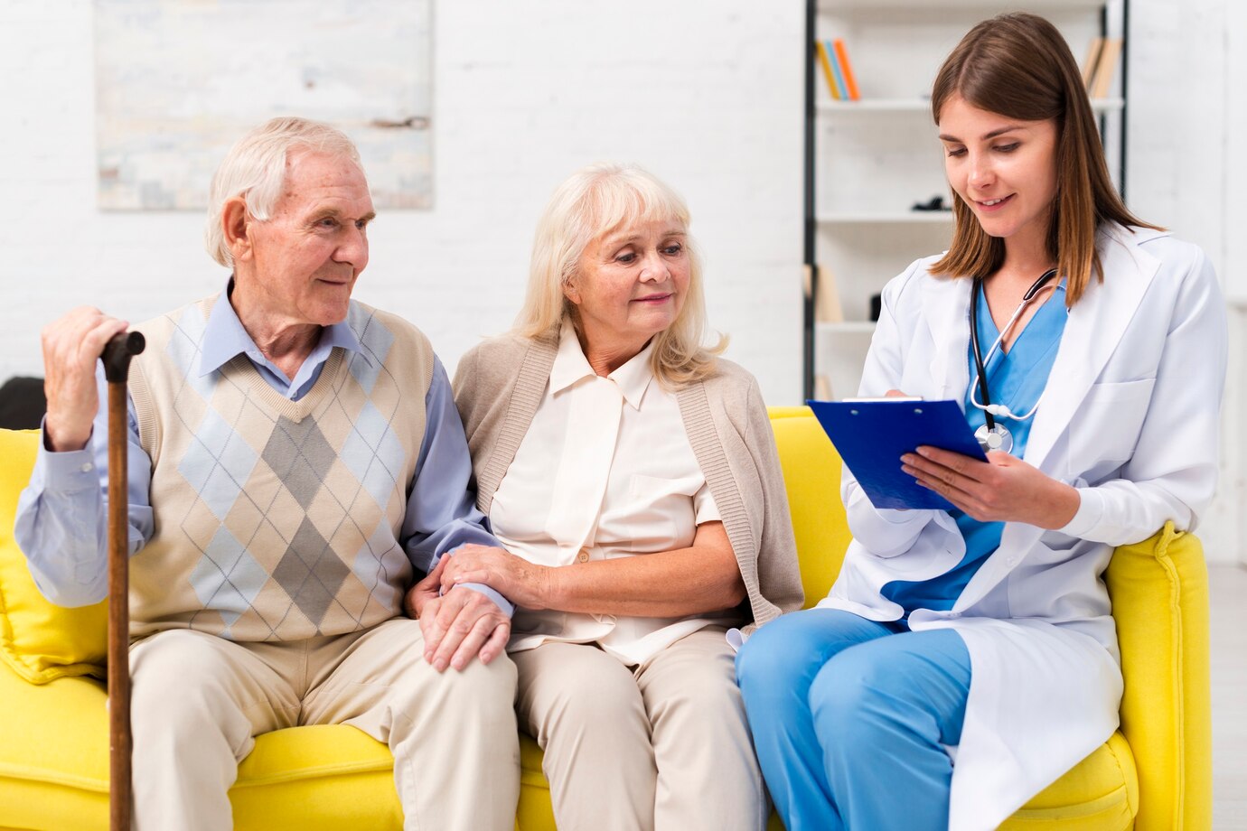 nurse-sitting-with-old-man-woman-sofa_23-2148238964